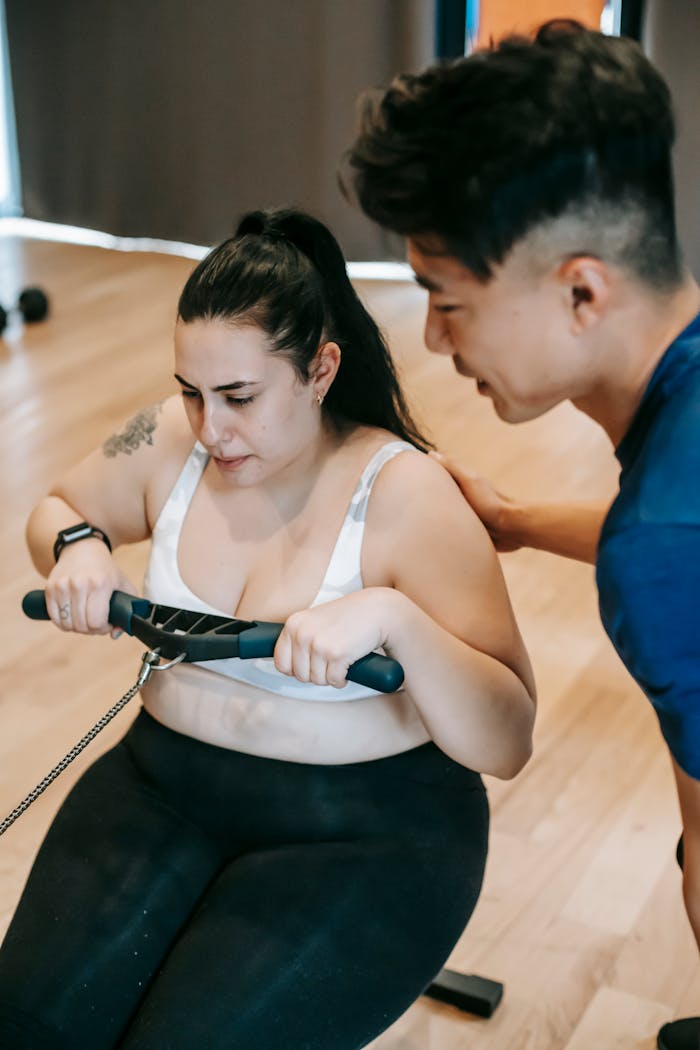 Coach soutenant une sportive pendant un exercice